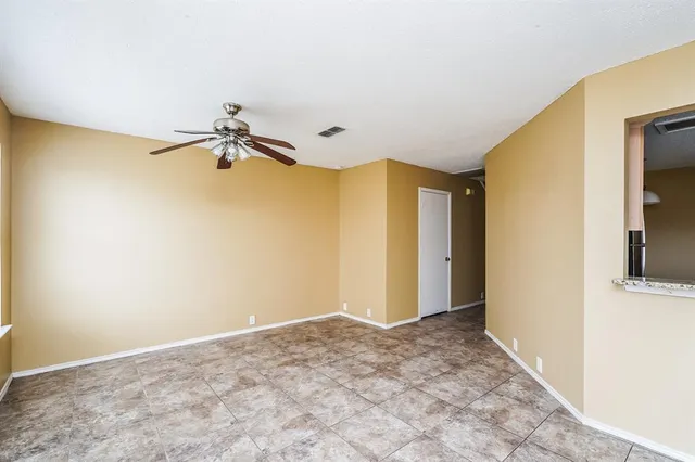 a view of a livingroom with wooden floor and a ceiling fan
