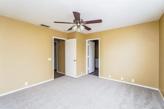 a view of a big room with chandelier fan