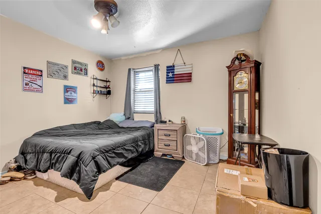 a bedroom with a bed and dresser