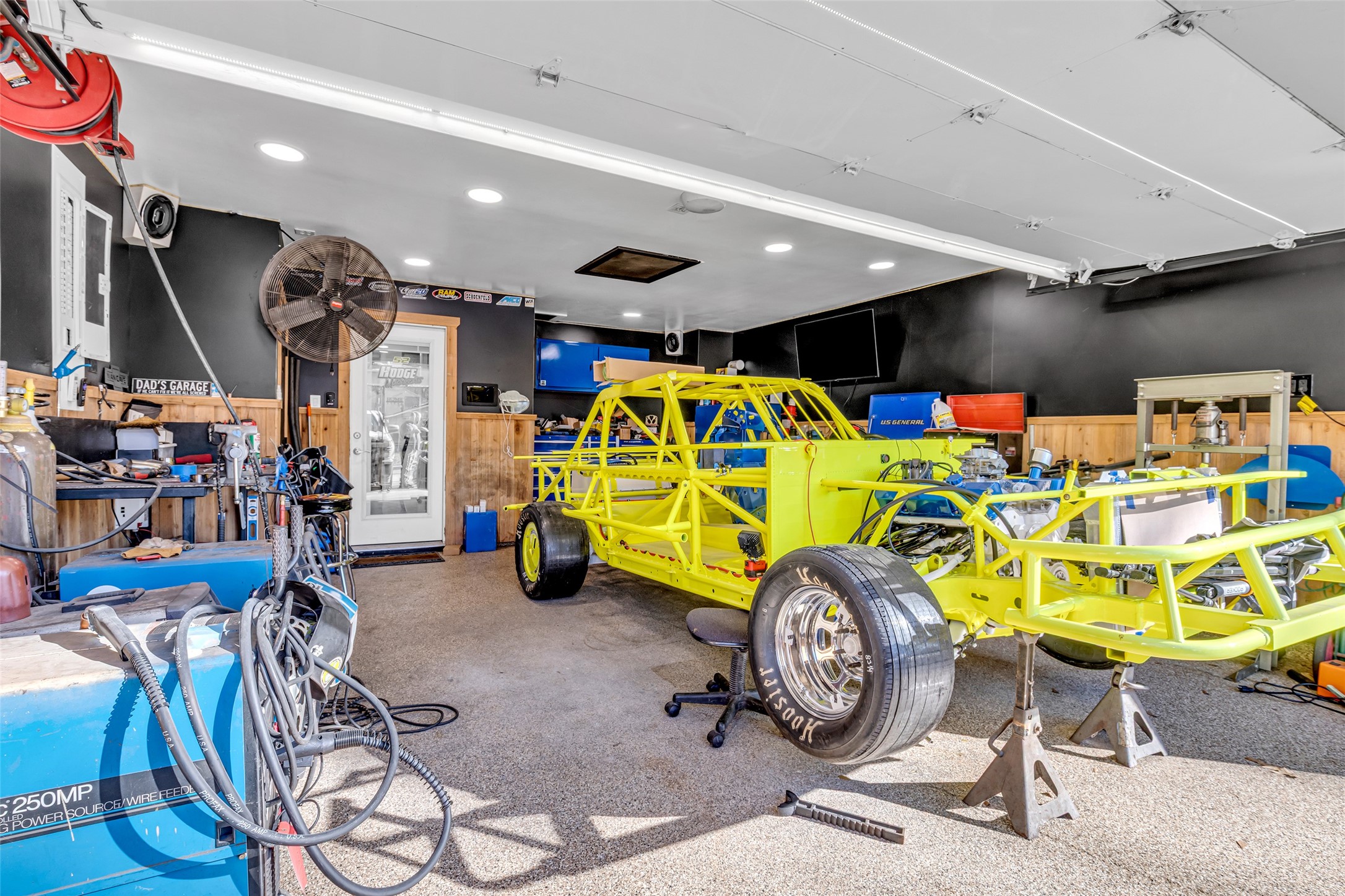 25473 White Oak Lane Splendora, TX 77372 - Photo 19 of 24 Renovated garage offers epoxy flooring, mini-split AC/heat, fire-barrier walls, and an insulated door—ideal for a workshop, gym, or flex space