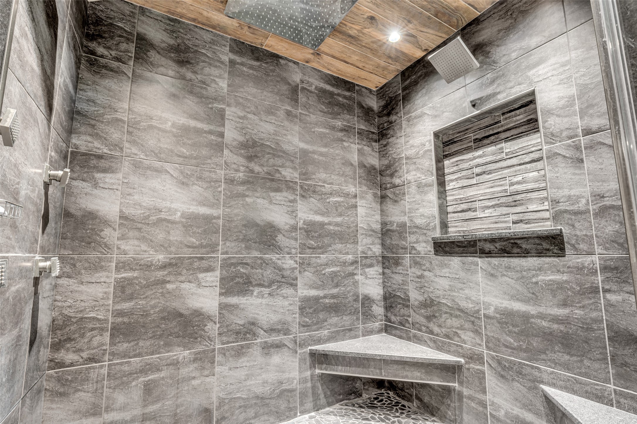 25473 White Oak Lane Splendora, TX 77372 - Photo 5 of 24 The primary suite includes a spa-like bathroom with an updated walk-in shower featuring body jets, rainfall showerhead, and a dedicated tankless water heater.