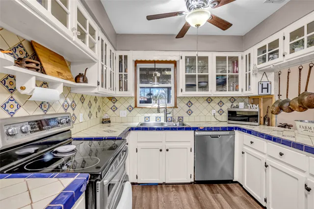 a kitchen with a sink stove and cabinets