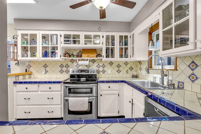 a kitchen with stainless steel appliances granite countertop a sink and cabinets