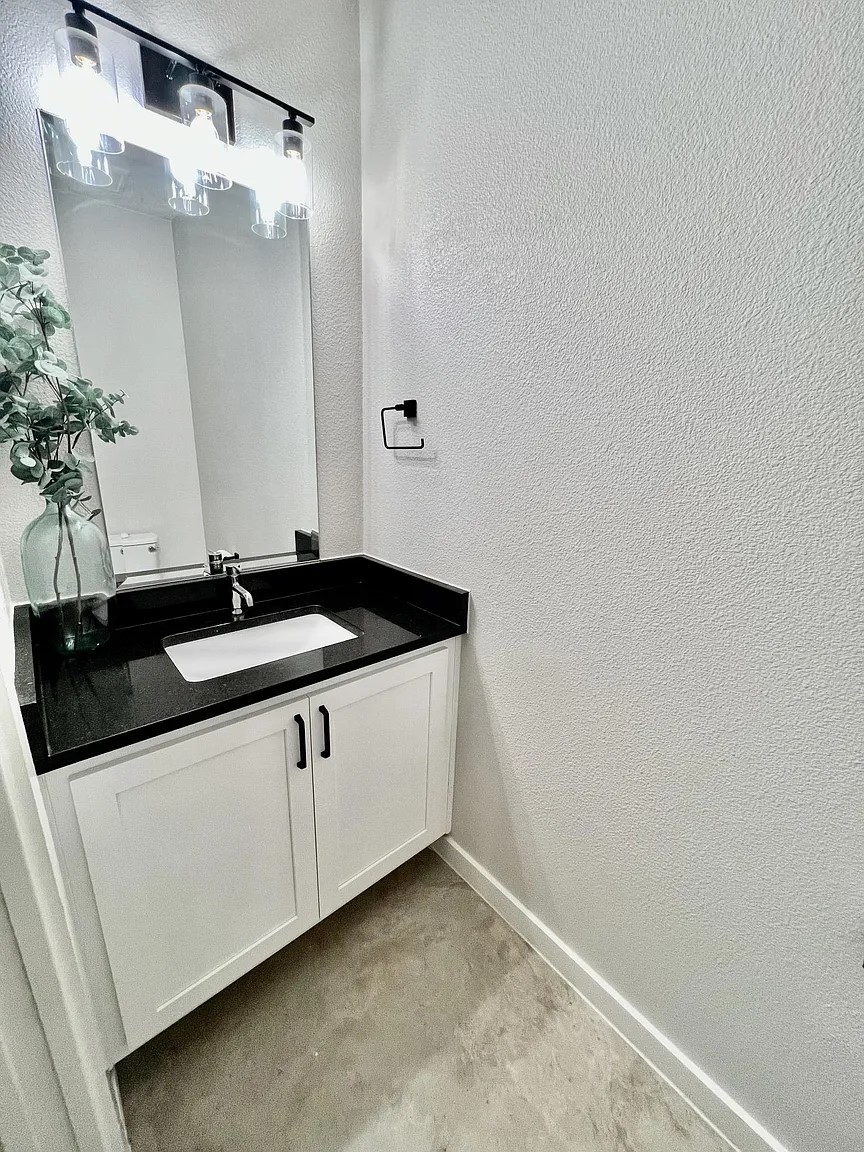 1924 Bunche Road, Unit A Austin, TX 78721 - Photo 13 of 14 Bathroom with a textured wall, vanity, and concrete floors
