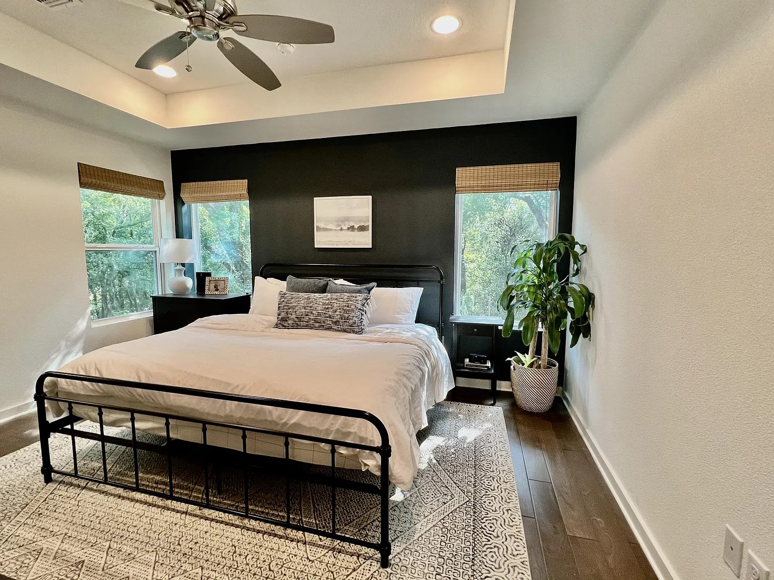 1924 Bunche Road, Unit A Austin, TX 78721 - Photo 9 of 14 Bedroom featuring dark wood finished floors, a ceiling fan, recessed lighting, a raised ceiling, and a textured wall