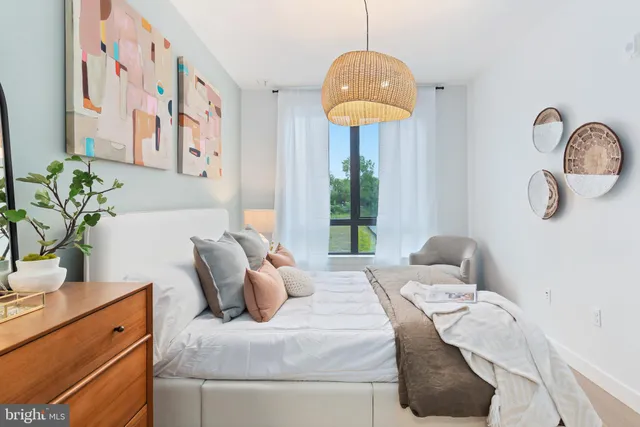 a bedroom with a bed and ceiling fan