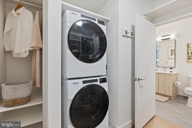 a view of a hallway with washer and dryer