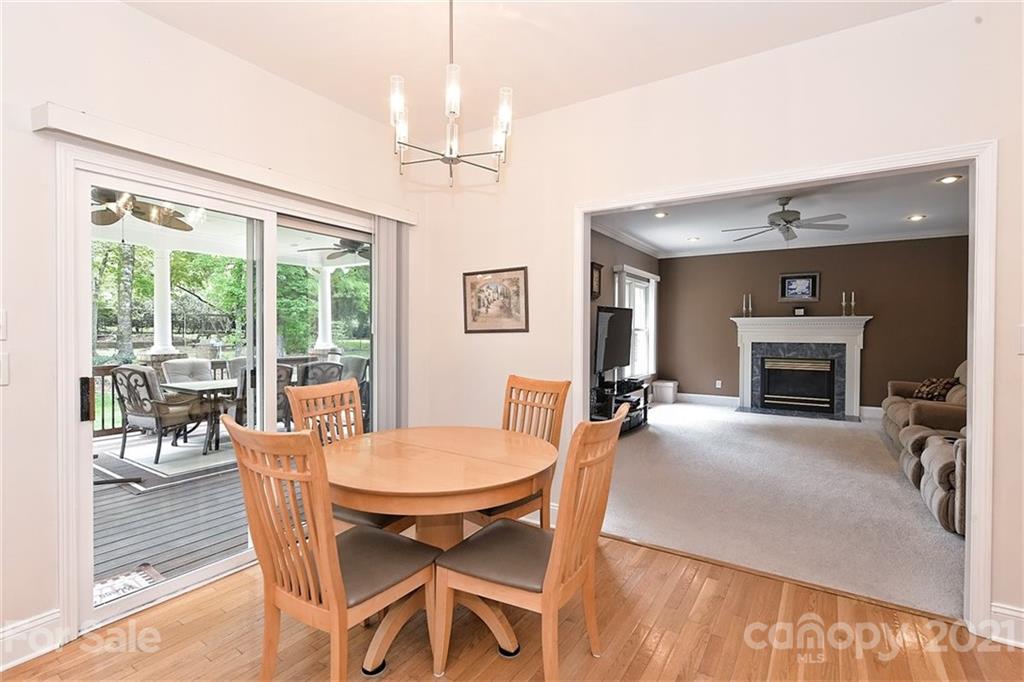 324 Gringley Hill Road Fort Mill, SC 29708 - Photo 12 of 48 a dining room with furniture a fireplace and wooden floor