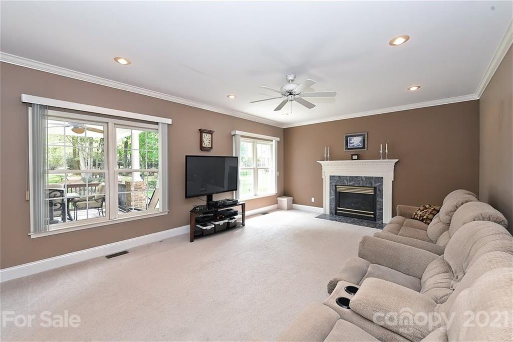 324 Gringley Hill Road Fort Mill, SC 29708 - Photo 13 of 48 a living room with furniture a fireplace and a flat screen tv