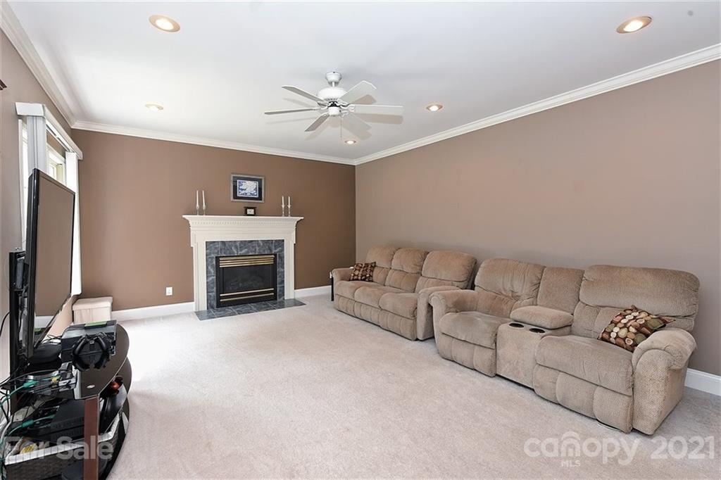 324 Gringley Hill Road Fort Mill, SC 29708 - Photo 14 of 48 a living room with furniture a fireplace and a flat screen tv