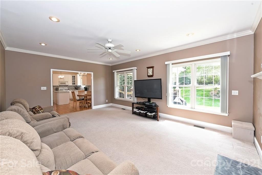324 Gringley Hill Road Fort Mill, SC 29708 - Photo 15 of 48 a living room with furniture a large window and a flat screen tv