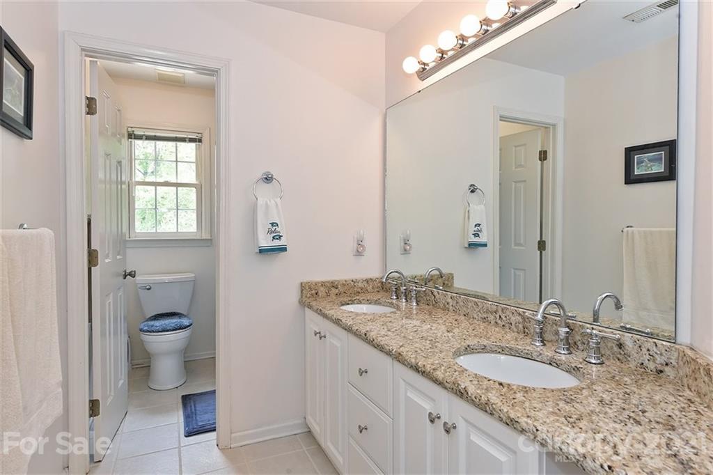 324 Gringley Hill Road Fort Mill, SC 29708 - Photo 24 of 48 a bathroom with a granite countertop sink and a mirror