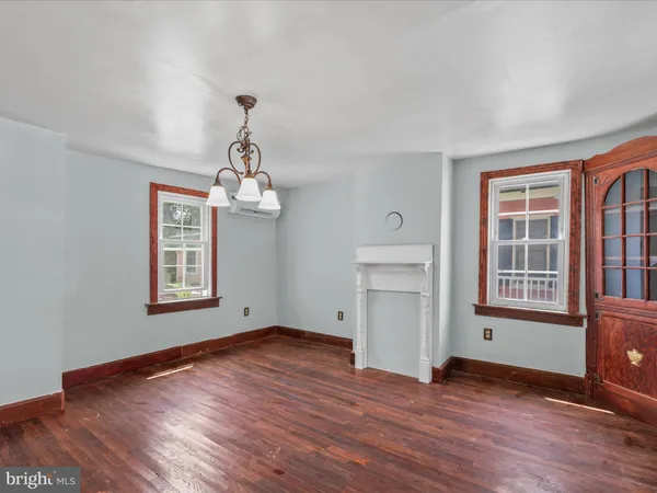 a view of a room with wooden floors and ceiling fan