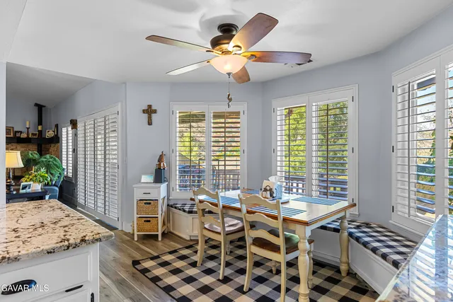 a view of a hallway with wooden floor and living room