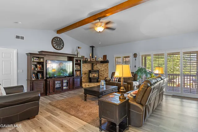 a living room with fireplace furniture and a flat screen tv