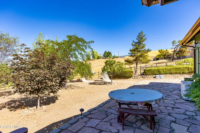 a front view of a house with a yard and potted plants