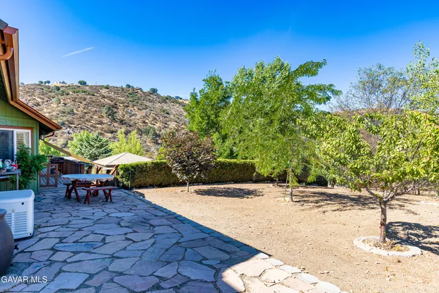 an aerial view of a house with a yard and wooden fence