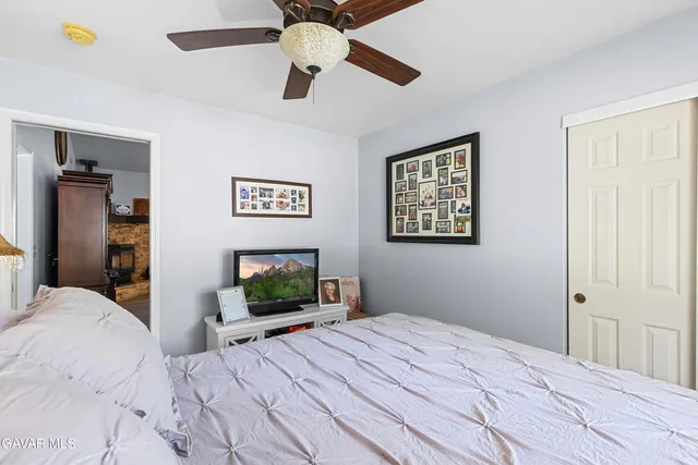 a kitchen with stainless steel appliances kitchen island granite countertop a sink a stove and white cabinets