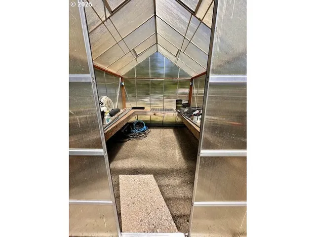 a bedroom with furniture and a large window