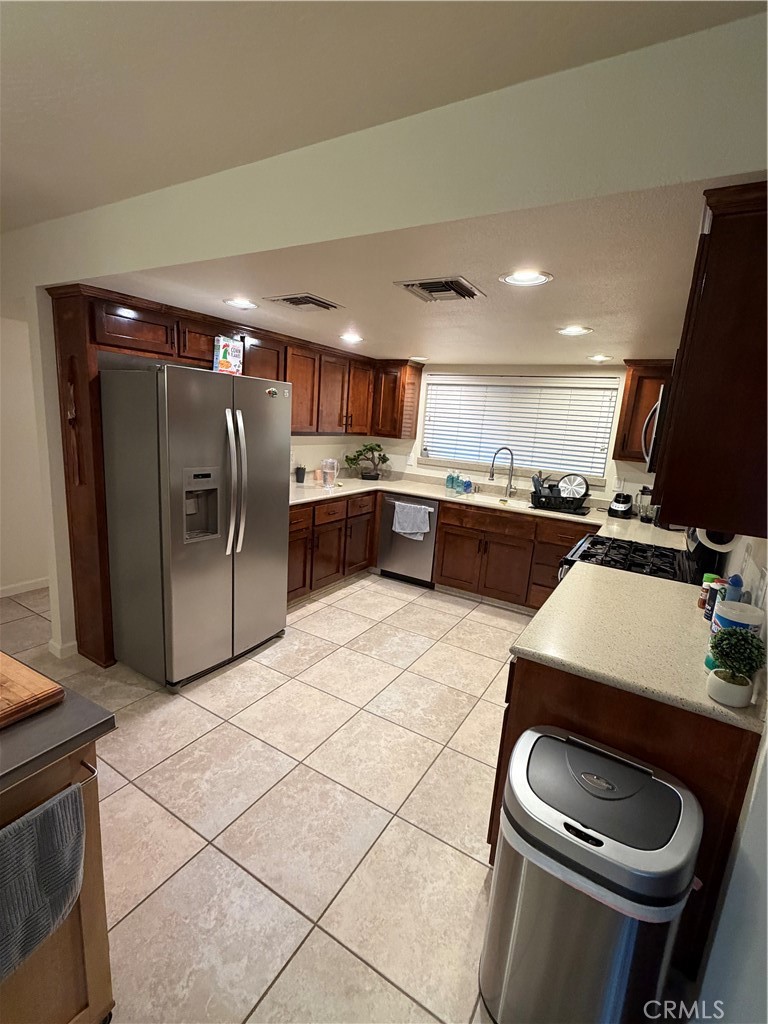 209 Kimberly Lane Ridgecrest, CA 93555 - Photo 16 of 62 a kitchen with stainless steel appliances granite countertop a sink stove and refrigerator