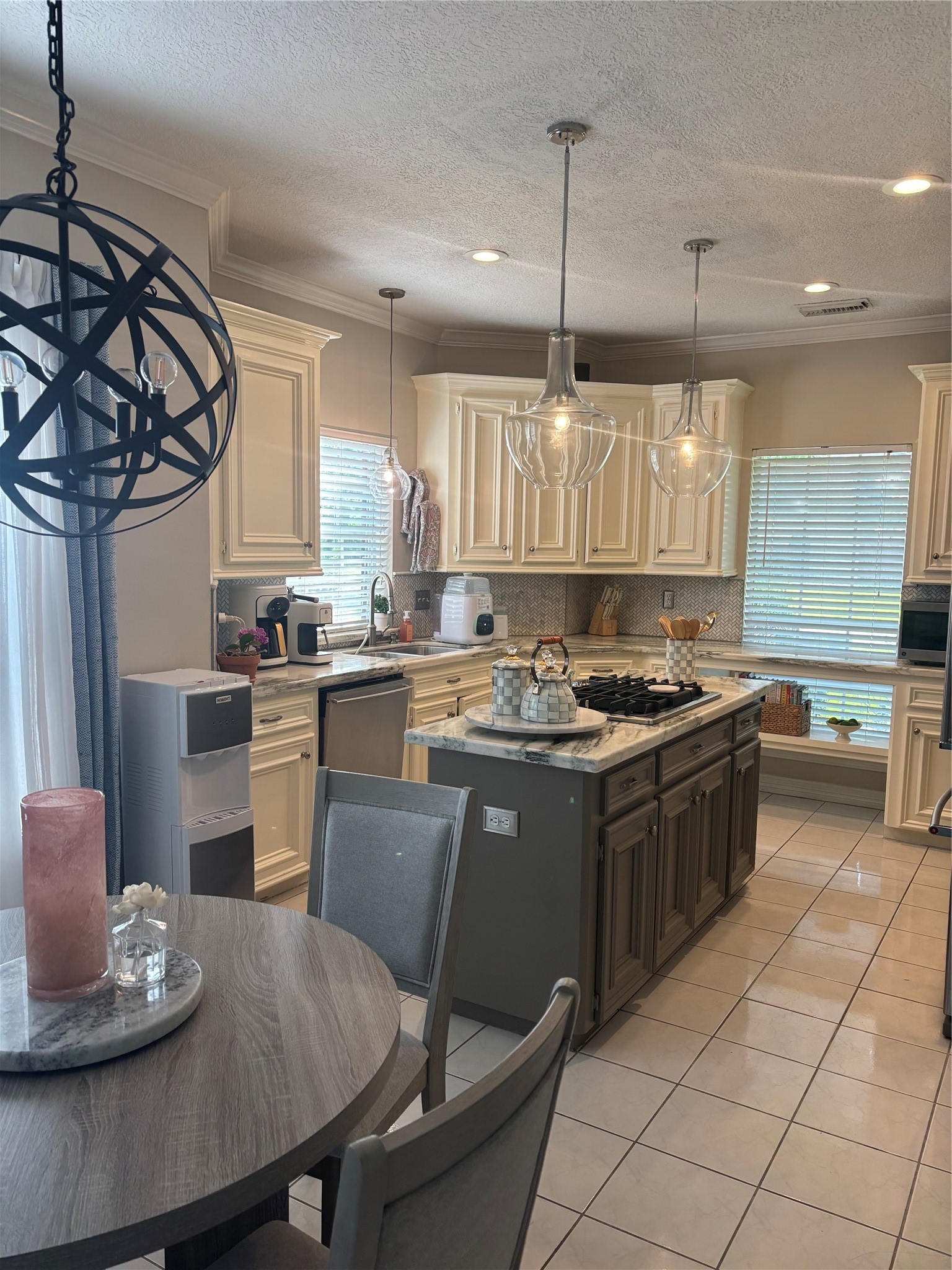 8915 Herts Road Spring, TX 77379 - Photo 2 of 7 a kitchen with stainless steel appliances granite countertop a sink a stove a refrigerator a dining table and chairs