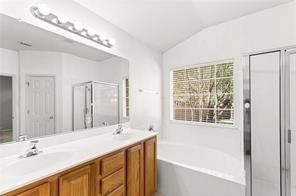 10708 Sycamore Hills Road Austin, TX 78717 - Photo 8 of 10 a bathroom with a tub a sink and a large mirror