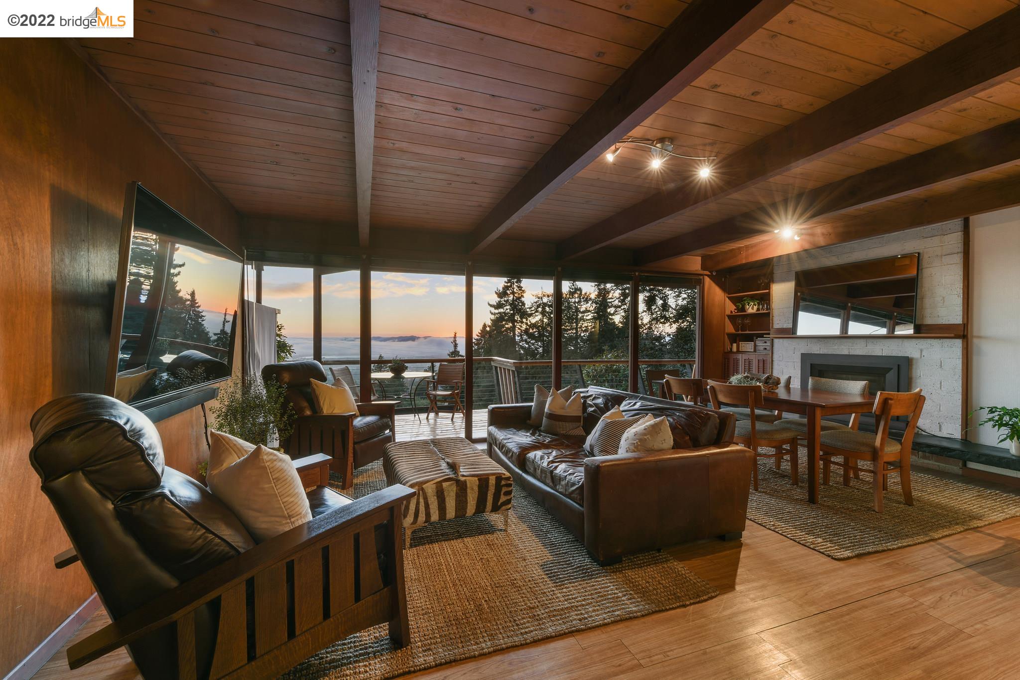 a living room with fireplace furniture and a large window