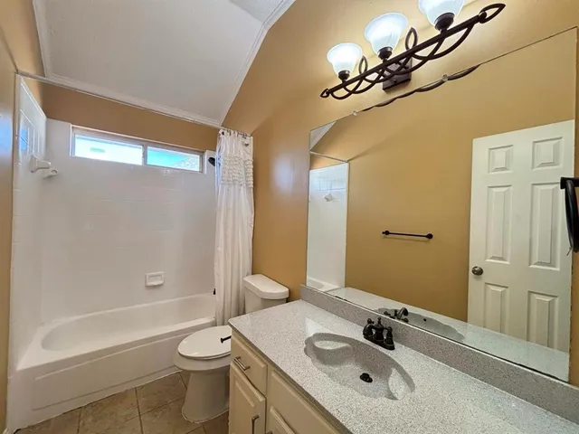 a bathroom with a double vanity sink toilet and shower