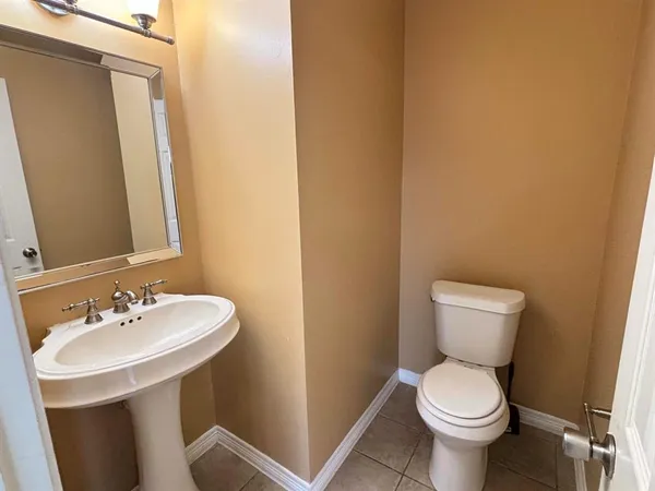 a bathroom with a sink toilet and a mirror