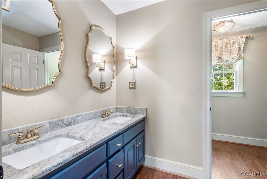 2949 Sandy Hook Road Sandy Hook, VA 23153 - Photo 37 of 49 a en suite bathroom with a double vanity sink and a mirror