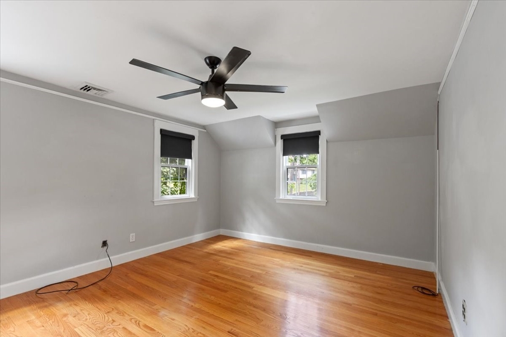 5 Windsor Road Stoneham, MA 02180 - Photo 20 of 37 a view of a big room with wooden floor and a window
