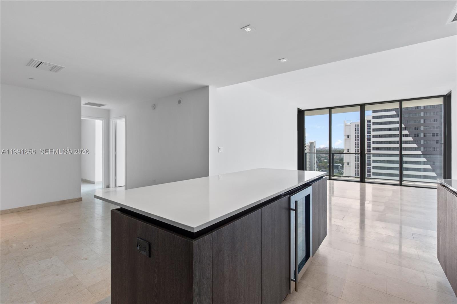 88 Southwest 7th Street, Unit 904 Miami, FL 33130 - Photo 7 of 26 a kitchen with a wooden floor and large window