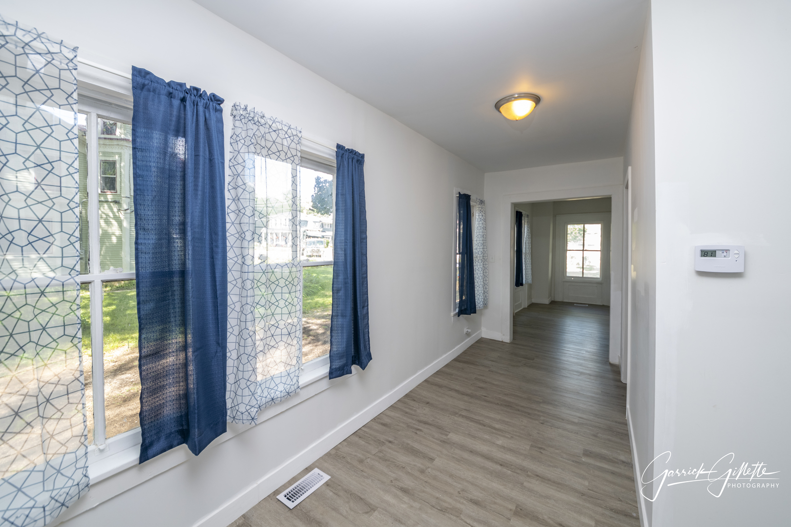 213 North Main Street Sandwich, IL 60548 - Photo 11 of 24 a view of a hallway with wooden floor and windows