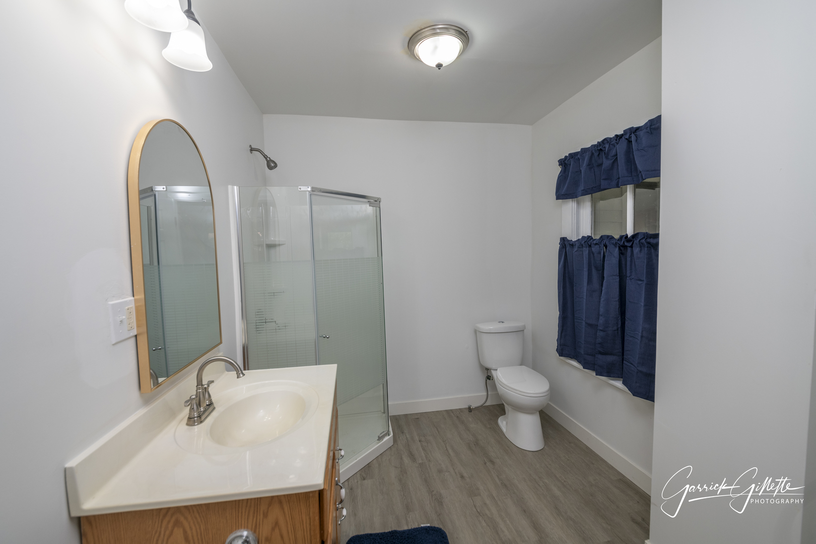 213 North Main Street Sandwich, IL 60548 - Photo 12 of 24 a bathroom with a sink a toilet and shower