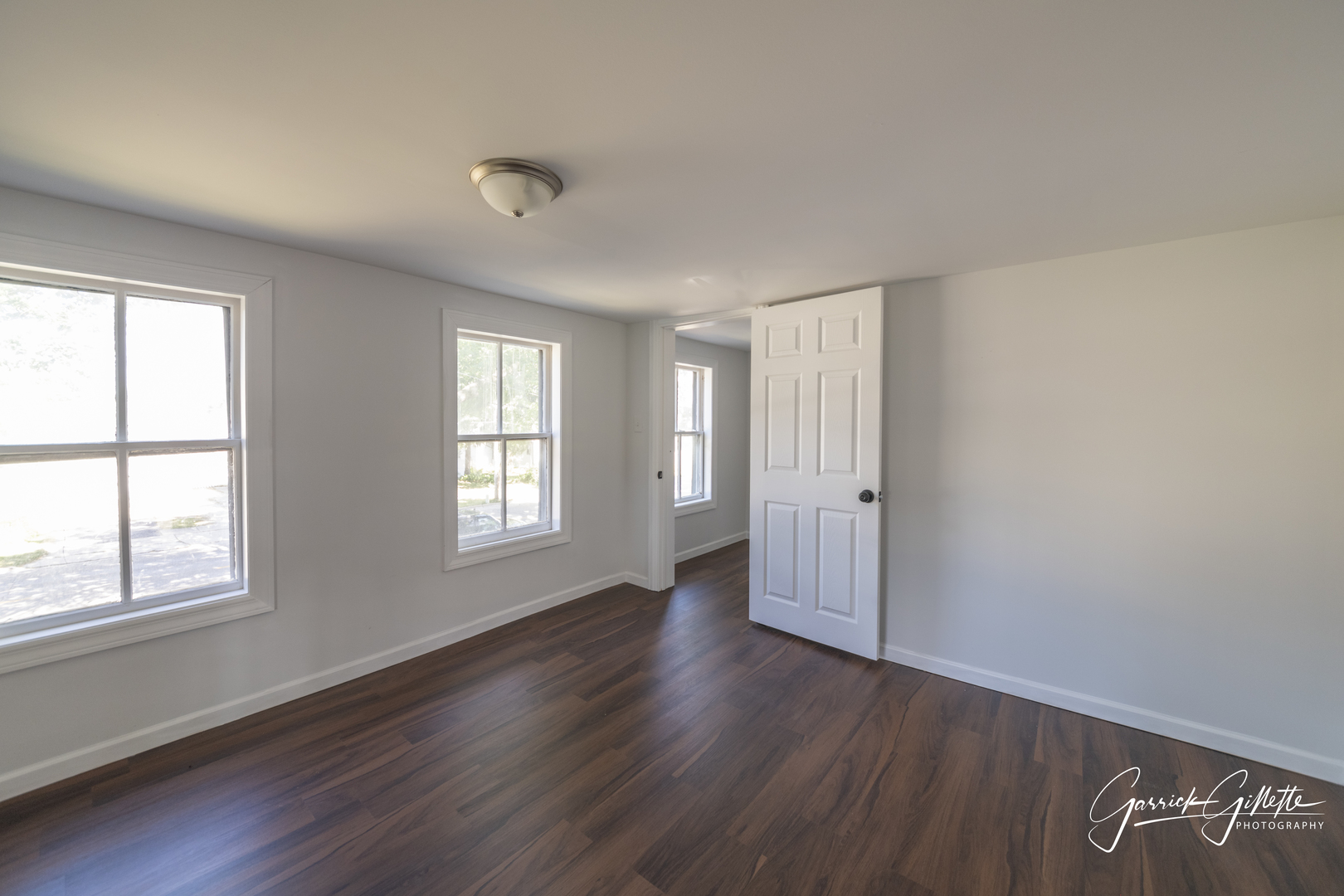 213 North Main Street Sandwich, IL 60548 - Photo 15 of 24 an empty room with wooden floor and windows