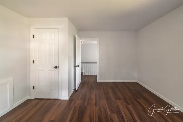 a view of a small space with wooden floor and a window
