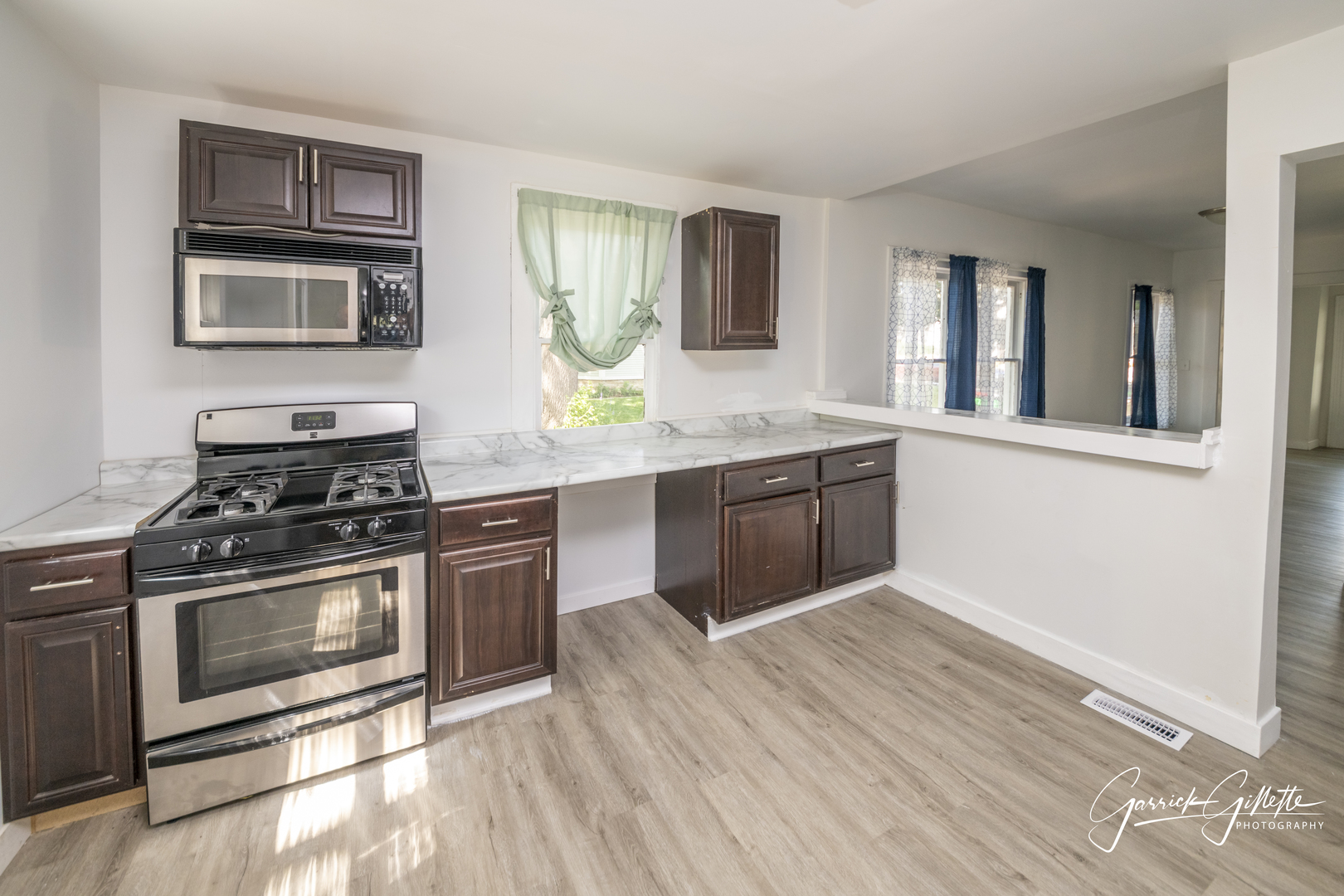 213 North Main Street Sandwich, IL 60548 - Photo 9 of 24 a kitchen with stainless steel appliances granite countertop a stove and a sink