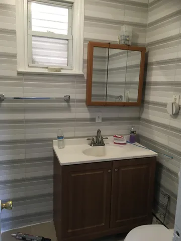 a bathroom with a sink and a mirror