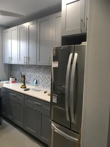 a kitchen with stainless steel appliances granite countertop a refrigerator and a sink