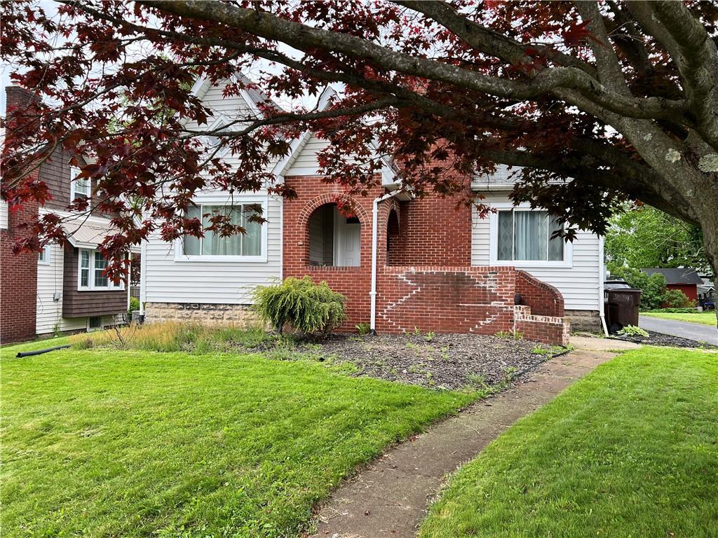 406 Service Avenue Sharon, PA 16146 - Photo 2 of 17 a front view of a house with a yard