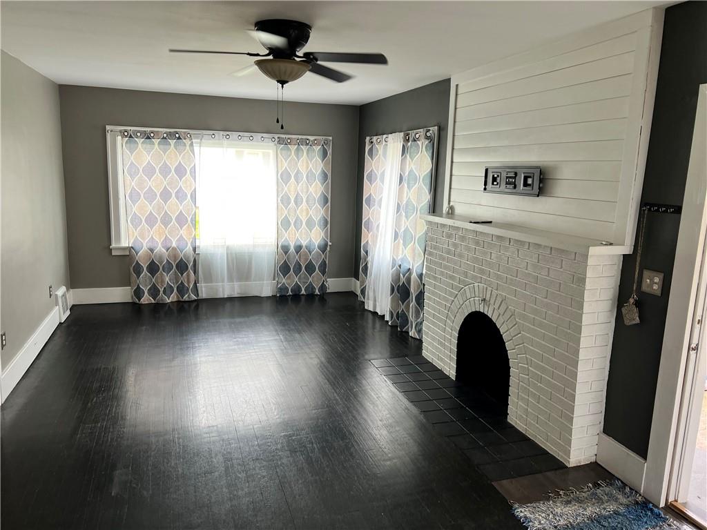 406 Service Avenue Sharon, PA 16146 - Photo 3 of 17 a view of an empty room with wooden floor and a window