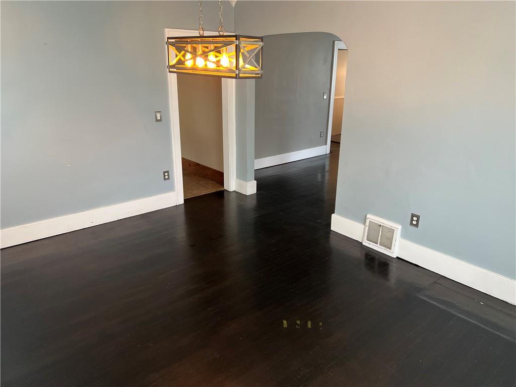 406 Service Avenue Sharon, PA 16146 - Photo 7 of 17 an empty room with wooden floor cabinet and windows