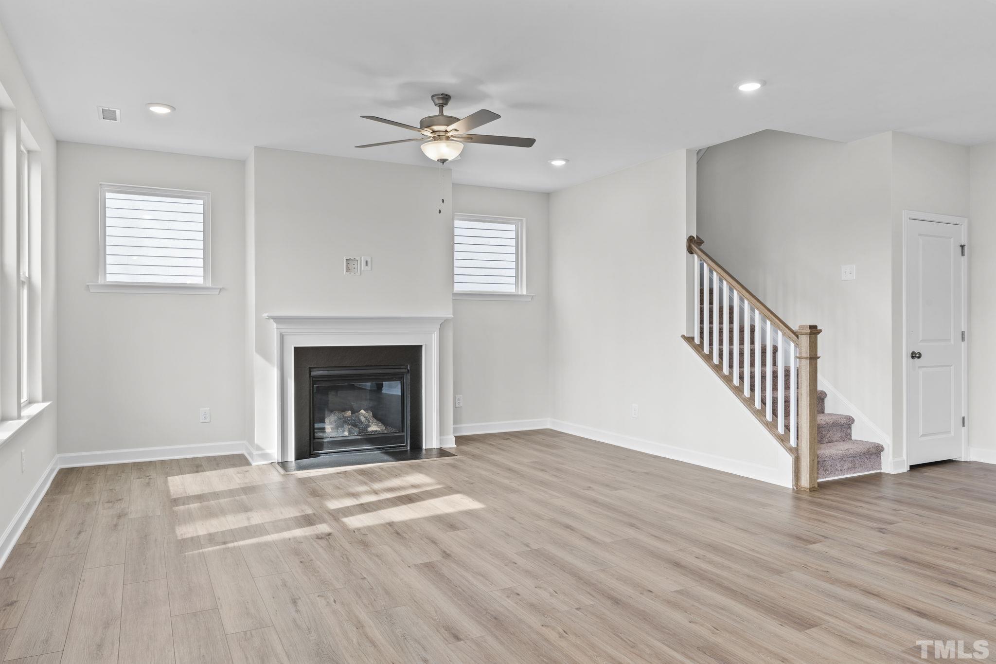 516 Craftsman Rdg Trail Knightdale, NC 27545 - Photo 13 of 45 a view of an empty room with wooden floor fireplace and a window