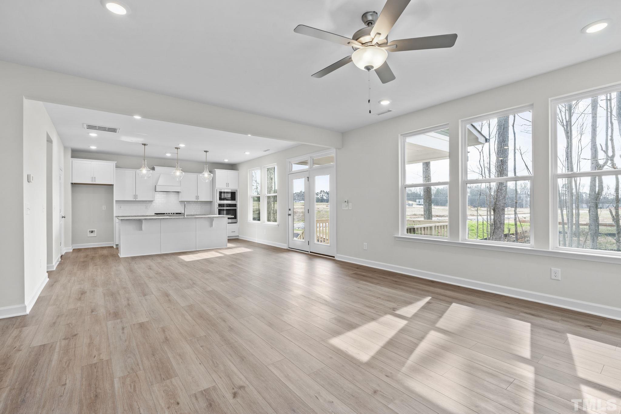 516 Craftsman Rdg Trail Knightdale, NC 27545 - Photo 15 of 45 a view of an empty room with a window and wooden floor