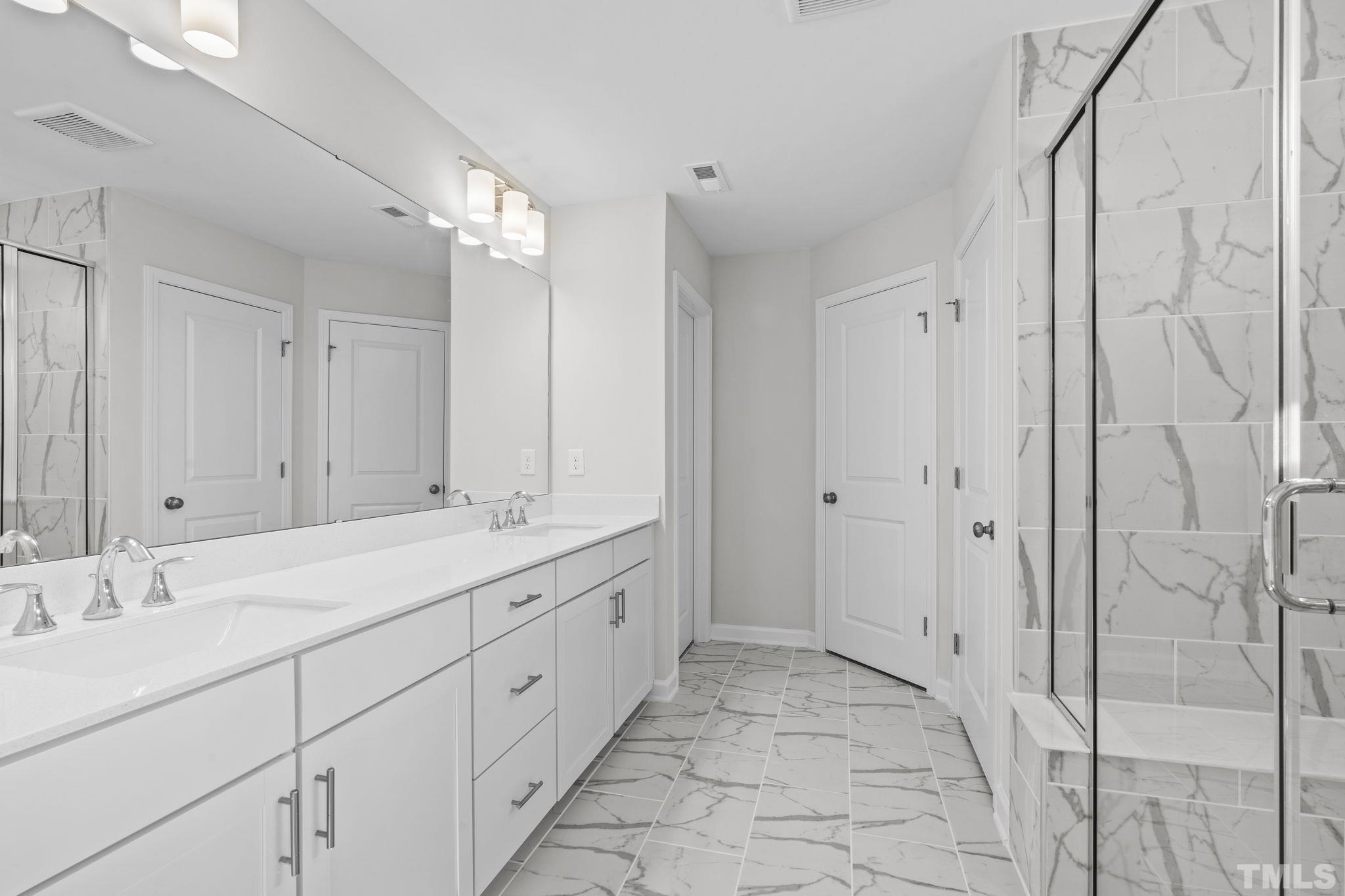 516 Craftsman Rdg Trail Knightdale, NC 27545 - Photo 21 of 45 a bathroom with a double vanity sink and a mirror