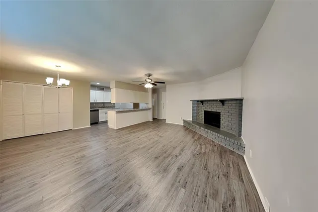 a view of a kitchen with a sink and a fireplace