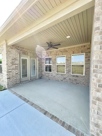 front view of a brick house with a large window