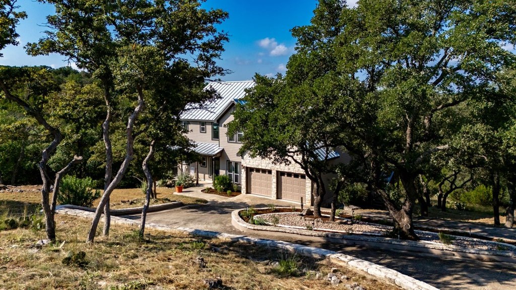502 Lost Valley Kerrville, TX 78028 - Photo 3 of 70 a backyard of a house with barbeque oven table and chairs