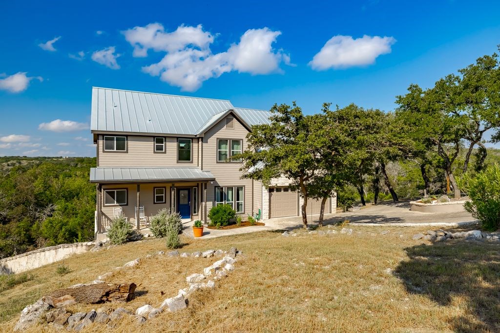 502 Lost Valley Kerrville, TX 78028 - Photo 7 of 70 a view of a white house with a yard and plants