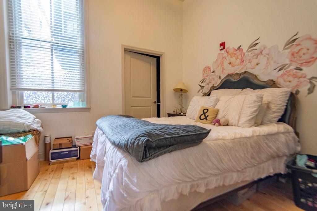 1310 Spruce Street, Unit 101 Philadelphia, PA 19107 - Photo 5 of 7 a bedroom with a bed and a couch